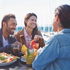 Friends dining and drinking outside on patio