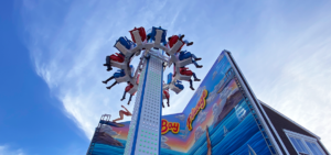 The Bay Plunge attraction with people on it up in the air