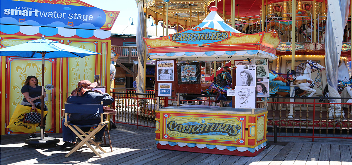 Caricatures stand in front of the carousel