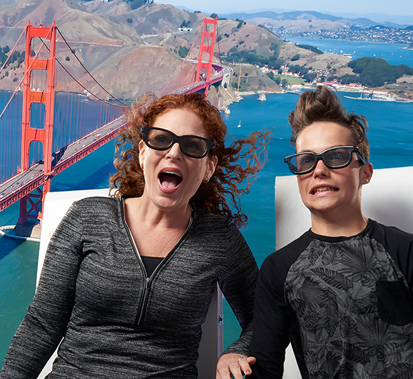 Mother and boy on The Flyer ride with Golden Gate Bridge in background