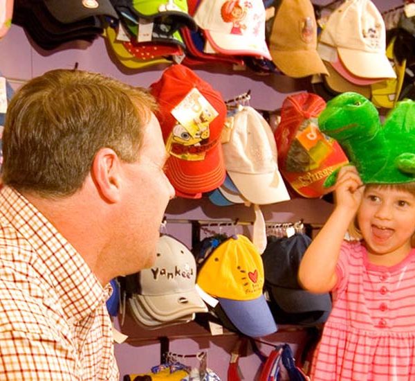 Child and father trying on hats at Krazy Kaps