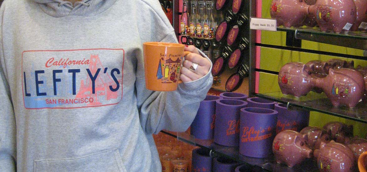 Left-handed coffee much and close up of sweatshirt at Lefty's