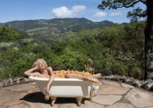 Trish Conklin in a bath tub full of mini donuts