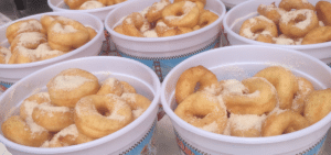 Buckets of Trish's Mini Donuts with sugar